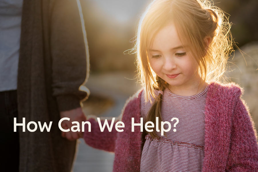 Photo of a little girl holding her mother's hand